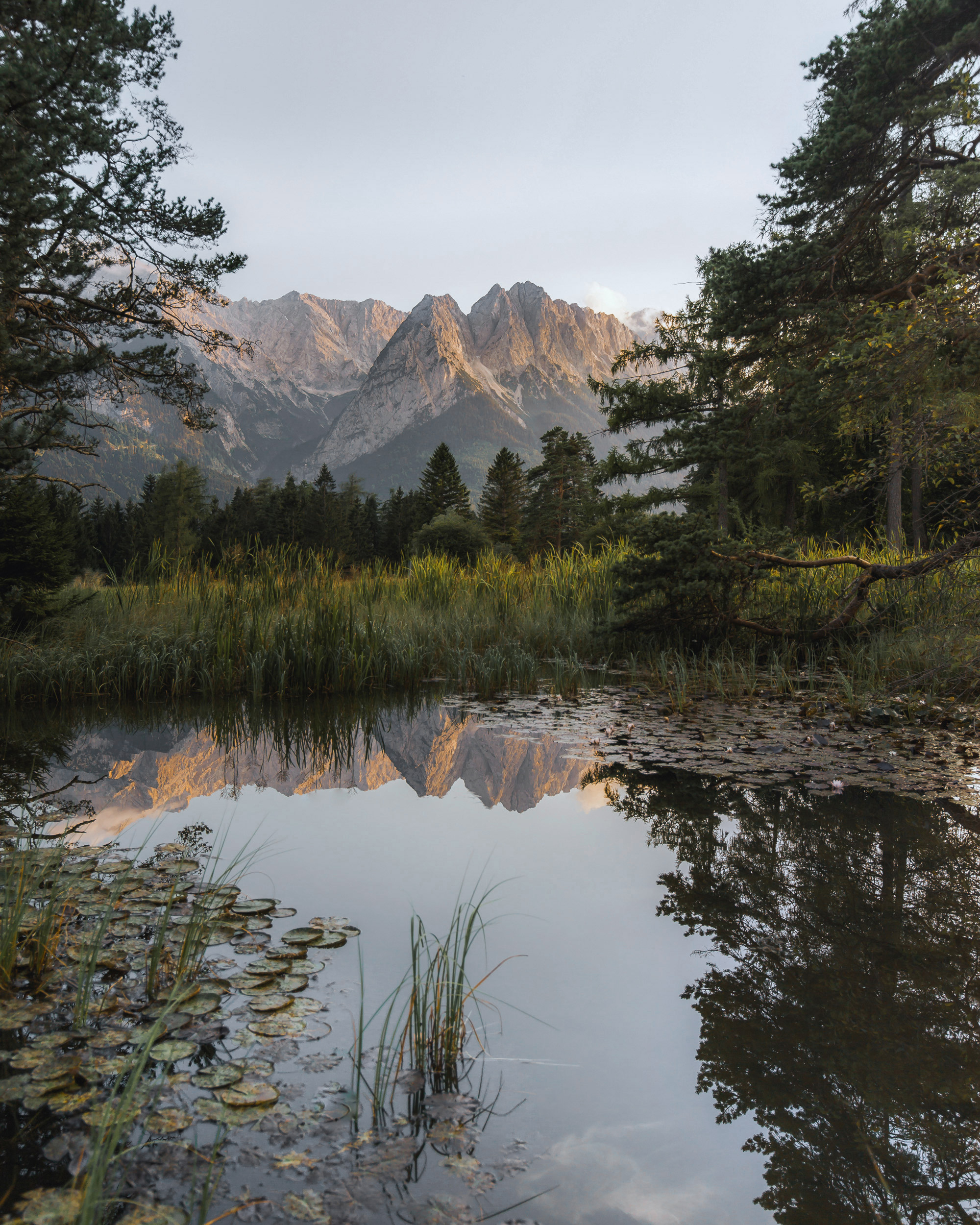 Picturesque alpine landscape, with the mountains perfectly reflected in the water.