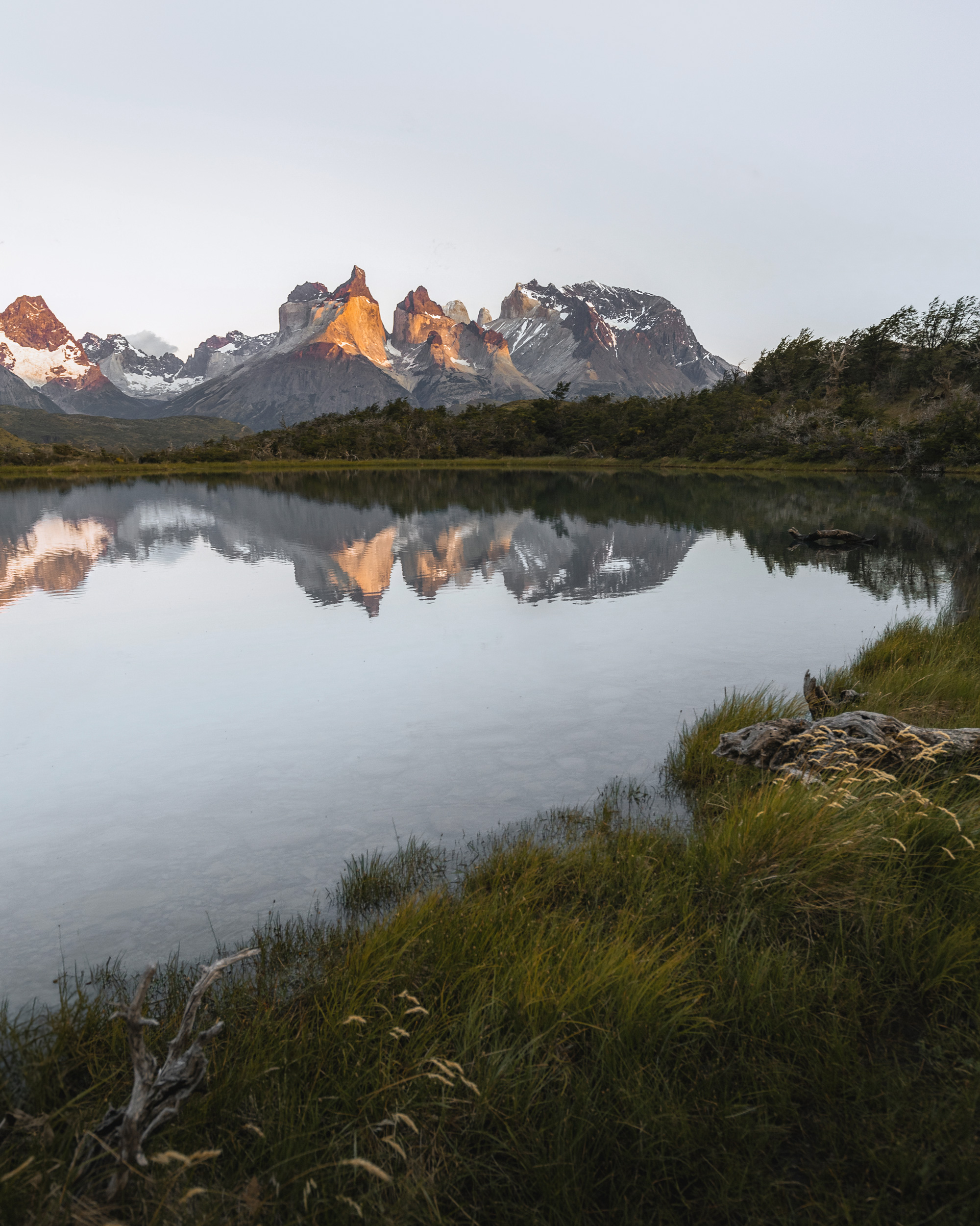 Serene lake reflecting the majestic peaks of Los Cuernos.